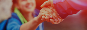 An image of two individuals shaking each others hand.