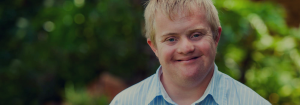 A young man smiling.