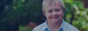 A young man smiling.
