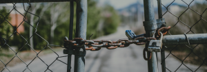 A closed chained fence that is padlocked.