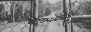 A closed chained fence that is padlocked.