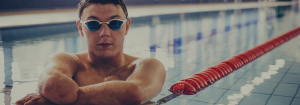 A man with a disability inside a swimming pool.