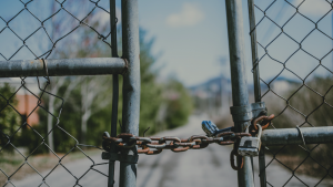 A closed chained fence that is padlocked.
