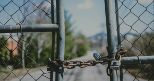 A closed chained fence that is padlocked.