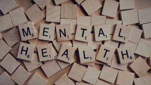 The words "mental health" on a scrabble board.