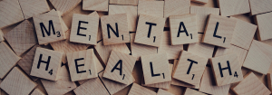 The words "mental health" on a scrabble board.