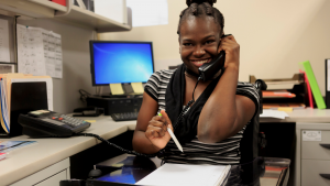 Christie on the phone while working at her desk.