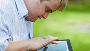 David using his tablet outside.