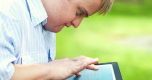 David using his tablet outside.