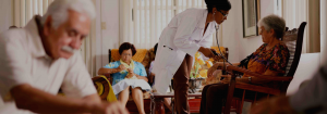 A nurse, with stethoscope, taking the pulse of a elderly woman.