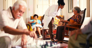 A nurse, with stethoscope, taking the pulse of a elderly woman.