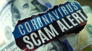 A hundred dollar bill with the words" coronavirus scam alert" written on top