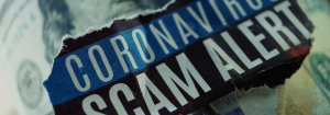 A hundred dollar bill with the words" coronavirus scam alert" written on top