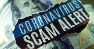 A hundred dollar bill with the words" coronavirus scam alert" written on top