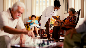 A nurse, with stethoscope, taking the pulse of a elderly woman.