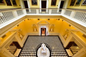 Image of empty lobby of Virginia state capital building. Ther are balconies on all four sides, looking down at an emtpy rectangular space.