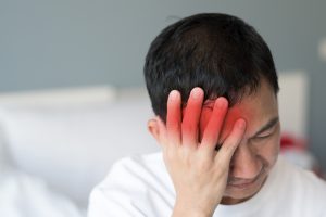 Migraine symptoms in businessman. Man suffering from pulsating pain of one sided headache. People medical healthcare concept