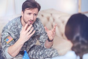 You cannot even imagine what I have been through. Military man gesturing while sitting at a therapist office and talking about his life as a military servant.
