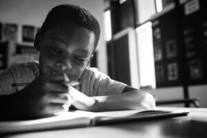 Boy writing in book