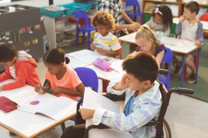 Students in their classroom reading and working on schoolwork