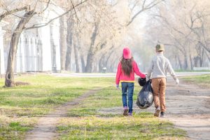 Kids carrying a black bag
